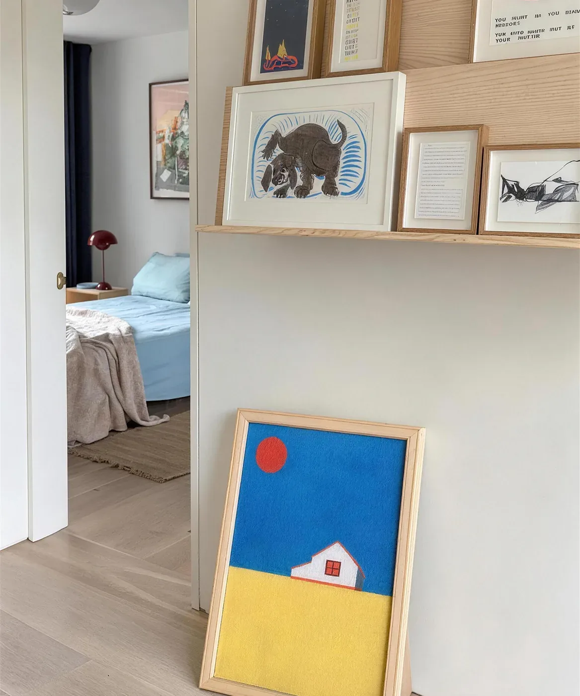 The Sunny Field canvas leaning in a bright hallway between bedrooms