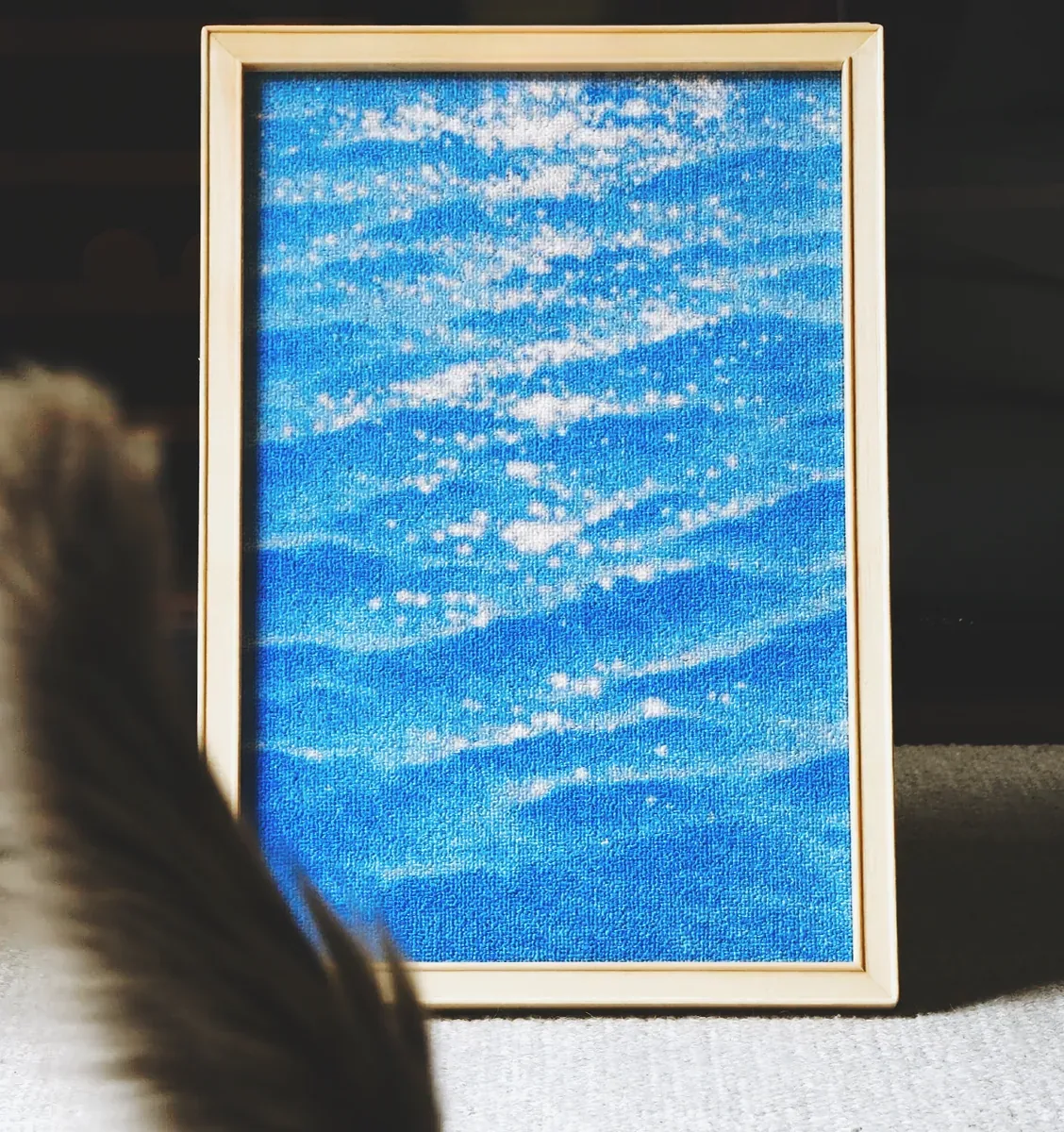 The wave canvas panel of the house at night, a cat tail in the foreground