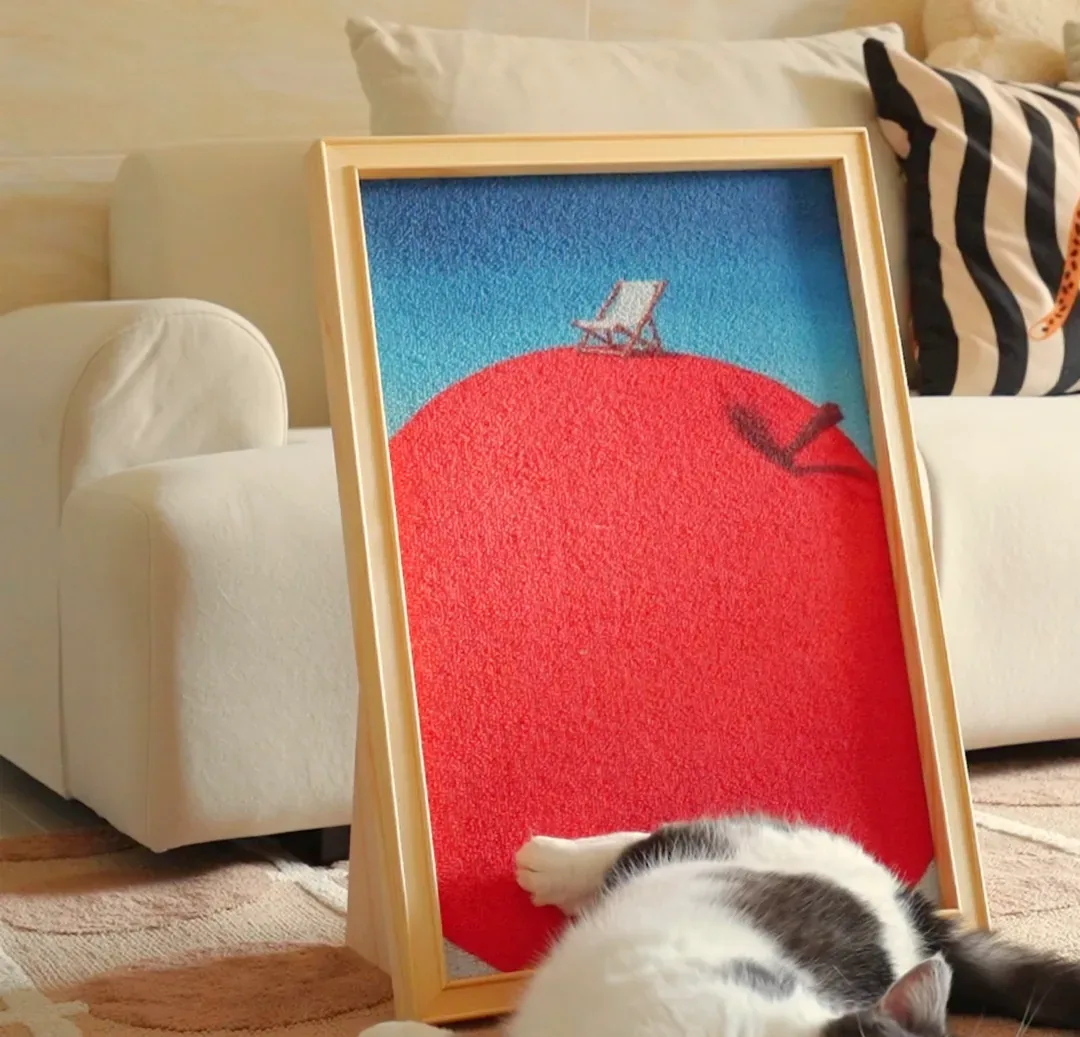 The Canvas Scratcher at home: a framed canvas leaning by a sofa, cat asleep beside it